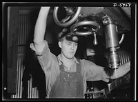 Manpower. Americans all. Like most of the young workers in a huge Midwest medium-tank plant, Herman Silldorf is an American of foreign-born parents. A skilled machine operator, young Silldorf, whose parents came here from Germany, processes parts for medium tanks with the hope that some day soon he'll be driving one of those tanks, taking a direct (instead of an indirect) slap at the Axis. Pressed Steel Can Company, Chicago, Illinois. Sourced from the Library of Congress.