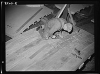 Production. Submarine chasers. The transom, or stern piece, of a wooden subchaser for the Navy is planed smooth before it is attached to the keel at an Eastern boatyard. Marine Construction Company, Stamford, Connecticut. Sourced from the Library of Congress.