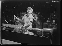 Production. Machine guns of various calibers. Walter Newman, operator of a high-speed lathe in a large firearms plant, performs an operation on the barrel of a machine gun. Many women workers are also employed in this plant producing essential weapons for the armed forces. Sourced from the Library of Congress.