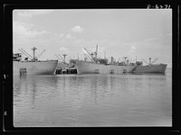 Ship launching in Portland, Maine. Some of the five British cargo-carrying ships built under lend-lease at a large New England yard and launched along with two destroyers and one liberty ship at a record breaking mass launching August 16, 1942. Sourced from the Library of Congress.