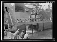 Ship launching in Portland, Maine. A second gate is opened, water floods the basin and another ship takes the water at a New England shipyard at a mass launching on August 16, 1942, in which eight vessels went into service. Sourced from the Library of Congress.