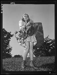 Manpower, junior size. She's put her playthings aside for a more important game. This Roanoke, Virginia youngster is one of America's thousands of school age boys and girls who are self-appointed scrap collectors for the duration. Sourced from the Library of Congress.