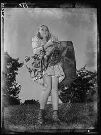 Manpower, junior size. She's put her playthings aside for a more important game. This Roanoke, Virginia youngster is one of America's thousands of school age boys and girls who are self-appointed scrap collectors for the duration. Sourced from the Library of Congress.