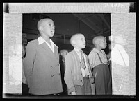 Manpower, junior size. Junior commando spirits ran high when children of all creeds and colors sang together the national anthem. Roanoke, Virginia school children took the initiative in mobilizing the first intensified junior commando organization to collect scrap for America's fighting forces. Sourced from the Library of Congress.