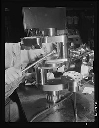 Production. Pratt and Whitney airplane engines. Crankshaft assembles for Pratt and Whitney airplane engines must undergo a rigid inspection in a large Eastern war plant now working full tilt to supply our armed forces with power installations for our war planes. Pratt and Whitney Aircraft. Sourced from the Library of Congress.