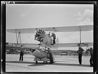 Naval air base, Corpus Christi, Texas. Last minute check-up is made by a sailor at the naval air base in Corpus Christi, Texas, before the N3N, a primary training sea plane, is launched. Sourced from the Library of Congress.