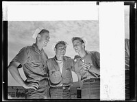 Naval air base, Corpus Christi, Texas. "And so he says to me...." sailor mechanics at the naval air base in Corpus Christi, Texas, laugh heartily over a good story between servicing operations on Navy planes. Sourced from the Library of Congress.