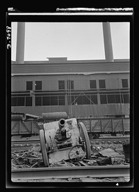 Salvage. Scrap for steel mills. A cannon that saw duty in World War I stands in the yard of a Chicago steel mill, ready to be melted down and processed into a modern weapon for World War II. Sourced from the Library of Congress.