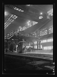 Salvage. Scrap for steel mills. From these giant rolling machines flow lengths of molten steel--steel composed partly of roller skates, reapers, radiators and other scrap collected from America's homes and farms. This strip steel will see action as armor plate on the nation's tanks or battleships. Sourced from the Library of Congress.