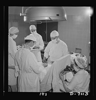 Nurse training. Young nurses assist at an appendectomy. This is part of the training with which every student nurse must be thoroughly conversant before she completes her training. With enough students to do this type of hospital work, graduate nurses can be released for duty with the armed forces. Sourced from the Library of Congress.