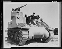 The M-7 is the Army's newest tank destroyer and is really a "killer." Being tested for desert warfare at Iron Mountains, California. It carries both a 105mm Howitzer and a 50 caliber gun. Lieutenant M. Hutchison of Enterprise, Alabama is at the extreme right. Corporal L. Roberts from Graham, Texas is at post behind the Howitzer. Corporal Downing, whose home is Dekalb, Missouri, is in the turret. Sourced from the Library of Congress.