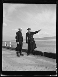 Manhattan Beach Coast Guard training station. Two of the ranking African American officers at the Manhattan Beach Coast Guard training station are coxswain Paul L. Perkins, drill commander of Company 24, and Boatswain and Warrant Officer Clarence Samuels is also a member of the Board of Education at Manhattan Beach Coast Guard training station and teaches practical seamanship and navigation. Sourced from the Library of Congress.