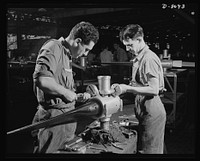 Production. Airplane propellers. Final assembly of blades into a two-way controllable Hamilton propeller for one of America's warships of the air. Leo Diana and George O'Meara are among the speedy, expert workers of the Hartford, Connecticut, plant, which is producing these propellers in great numbers. Sourced from the Library of Congress.