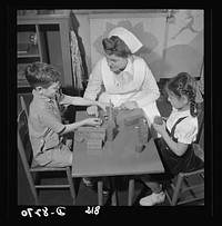 Nurse training. Construction toys help to rehabilitate convalescents and "ambulatory" patients. As a part of her nursing education, Susan Petty, student nurse, takes her turn at playing with the children and enlisting their interest in the activities of well youngsters. Sourced from the Library of Congress.