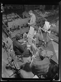 Production. B-17F heavy bomber. Cutting electrical conductor wire to specified length for use in the construction of B-17F (Flying Fortress) bombers at the Boeing plant in Seattle. The Flying Fortress, a four-engine heavy bomber capable of flying at high altitudes, has performed with great credit in the South Pacific, over Germany and elsewhere. Sourced from the Library of Congress.