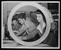 Mrs. Sophie Deneby of Honolulu is shown sending a pattern while John Popanich, apprentice moulder, and Frank Chiaco, pattern maker, discuss the blue prints of a pattern. Both civil service workers are from Pennsylvania. Sourced from the Library of Congress.