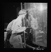 Production. B-17 heavy bomber. A woman riveter at the Boeing plant in Seattle attaches a sheet of the gleaming outer covering of a fuselage section for a new B-17F (Flying Fortress) bomber. The Flying Fortress has performed with great credit in the South Pacific, over Germany and elsewhere. It is a four-engine heavy bomber capable of flying at high altitudes. Sourced from the Library of Congress.