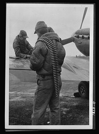 Reciprocal aid. Sergeant A. Baker and Technical Sergeant Roy Hill, both from Texas, prepare to load their plane with British bullets, part of the supplies furnished to American fighting forces under the British Reciprocal Aid Program. Sourced from the Library of Congress.