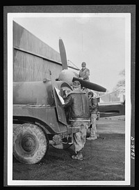 Reciprocal aid. British equipment plays an important part in supplying U.S. Army Air Forces in Britain. Here a British "Bowser" staffed by American airmen is used for refueling a plane. Sourced from the Library of Congress.