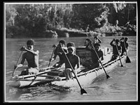 Natives aid Allied drive in New Guinea jungles. Dense jungles, deep ravines and high mountain ranges make transport extremely difficult for the Allied troops in the New Guniea area. Outrigger supply services, manned by natives, are of invaluable aid in waging tropic warfare. Sourced from the Library of Congress.