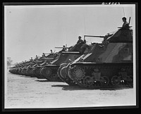 Australia in the war. American medium tanks and their Anzac crews lined up for review at a camp in Australia. Along with other lend-lease equipment, these tanks are helping in the development of a formidable Australian mechanized army. Sourced from the Library of Congress.