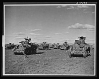 Australia in the war. American light tanks, manned by Australian crews, are playing an important role in the development of a formidable Australian mechanized army. The tanks shown here, provided by the United States under lend-lease, are being used in training armored crews. Sourced from the Library of Congress.
