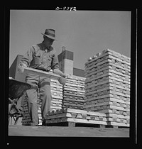 Production. Magnesium. Enormous asbestos mittens must be worn by men handling the thousands of hot magnesium ingots produced daily at Basic Magnesium's giant plant in the southern Nevada desert. A number of units of this plant are now in production. Full operation is scheduled for the summer of 1943. Sourced from the Library of Congress.