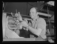 Baseball players in war production. "Frenchy" Uhalt, center fielder with Hollywood Club, puts his gloves aside to work in the research department at Douglas Aircraft. Sourced from the Library of Congress.