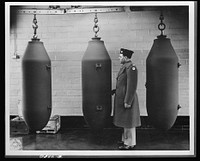 Production. Shell loading. These 2,000-pound bombs will carry death and destruction to the Axis from a huge shell-loading plant in the Midwest. The arsenal makes even deadlier gifts for Hitler--4,000-pound "block busters" and shells of still greater size. Ravenna ordnance plant. Sourced from the Library of Congress.