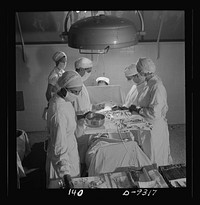 Nurse training. Calm and capable, these nurses are assisting at an appendectomy. The nurse in the foreground is arranging instruments to be handed to the surgeon. Sourced from the Library of Congress.