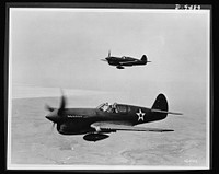 Planes in flight. The P-40 single-engine fighter plane--which the British have used in its various models as the "Tomahawk," "Kittyhawk" and "Warhawk"--is a fast pursuit ship in the 400-mile-per-hour class. It has an approximate service ceiling of 30,000 feet and a range of about 900 miles. Carrying various combinations of light and heavy caliber guns, it has performed notably with the RAF (Royal Air Force) in England and Africa, with the AVG (American Volunteer Group--Flying Tigers) in China and. with the AAF (Army Air Forces) in the South Pacific. Sourced from the Library of Congress.