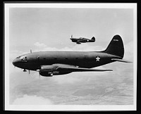 Planes in flight. The ship in the foreground is a C-46 transport, originally designed as a commercial plane to carry a crew of five men and thirty-six passengers. Its load capacity in military service has been greatly increased. The more distant plane is a P-40 fighter, distinguished for its effectiveness in middle-altitude work with the RAF (Royal Air Force) in England and Africa, with the AVG (American Volunteer Group--Flying Tigers) in China and with the AAF (Army Air Force) in the South Pacific. Sourced from the Library of Congress.