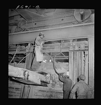 Production. Copper (refining). Charging sheets of copper produced by electrolysis into a furnace at a large copper refining operation. Large amounts of copper are produced for the war effort at the El Paso, Texas plant of Phelps-Dodge Refining Company. Sourced from the Library of Congress.