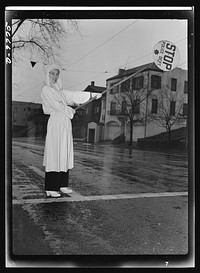 Women in essential services. Member of the Oakland, California Women's Safety Traffic Reserve, Mrs. E.K. Sabel helps to relieve the shortage of traffic policemen by guarding school zones. Sourced from the Library of Congress.