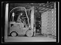 Women in essential services. Ethel Peterson, twenty-seven, an expert lift-truck operator at the Paraffine Company in Emeryville, California. Her job demands manual skill and excellent driving judgement, for sharp curves must be rounded and the cargo must be handled with precision and speed at all times. Sourced from the Library of Congress.