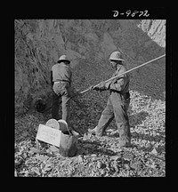 Utah Copper: Bingham Mine. Tamping a blasting charge at the open-pit mining operations of Utah Copper Company, at Bingham Canyon, Utah. Sourced from the Library of Congress.
