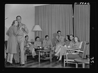 Reciprocal aid. American nurses and officers enjoy themselves in nurses' quarters of a new 3,000,000 dollar hospital "somewhere in Australia" which government of Australia has provided, without payment by the United States, for American servicemen recuperating from wounds and illness. Hospital is one of many Australian contributions under reciprocal lend-lease. Left to right: Miss Bertha Only, Middletown, New York; Major James Hipple, Pierre, South Dakota; Lieutenant R.A. Pearson, Jr., Raleigh, North Carolina; Miss Genevieve Kusek, Danvers, Massachusetts; Captain T.F. Connolly, Sacramento, California; Lieutenant Ray Loper, Cleveland, Oklahoma; Miss Julia Owens, Columbus, Georgia; Lieutenant Edward Ferreri, Connorsville, Indiana; Miss Sera Clifton, Harrington, Delaware. Sourced from the Library of Congress.