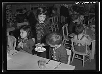 War workers' nursery. Playing waitress is an envied job at the Bella Vista Nursery School in Oakland, California, where a complete and nourishing luncheon is served daily in addition to midmorning cod liver oil and tomato juice and afternoon milk and crackers. Sourced from the Library of Congress.