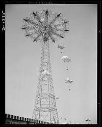 The four freedoms. Let'er rip, and carefree couples glide earthward from the top of Coney Island's famous parachute jump. Not shown are the milling crowds below, who enjoy the carefree screams of the people on the chutes as much as the brave chutists themselves. Sourced from the Library of Congress.