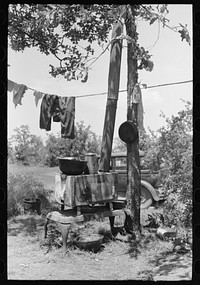 Stove and personal belongings of agricultural family camped by the roadside near Spiro. Sequoyah County, Oklahoma by Russell Lee
