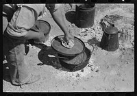 Lifting lid from kettle of chili made by the ranch cook at the roundup near Marfa, Texas by Russell Lee