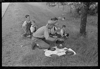 [Untitled photo, possibly related to: White migrant family eating lunch of berry pie on the highway east of Fort Gibson, Muskogee County, Oklahoma] by Russell Lee