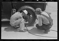 Migrants on the road checking tires at filling station near Henrietta [i.e., Henryetta,] Oklahoma by Russell Lee