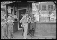 [Untitled photo, possibly related to: Group of men talking in street of Muskogee, Oklahoma] by Russell Lee