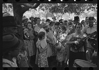 Group of people assembled under tree to listen to revival rally on Saturday afternoon, Tahlequah, Oklahoma by Russell Lee