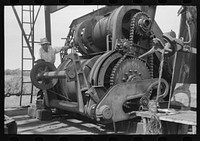 [Untitled photo, possibly related to: Cable tool equipment with operator. Oil well near Saint Louis, Oklahoma. This is equipment used in drilling] by Russell Lee