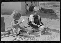 [Untitled photo, possibly related to: Children of Spanish-American farm family playing on wagon, Taos County, New Mexico] by Russell Lee