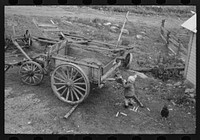 [Untitled photo, possibly related to: Wagon and agricultural equipmenmt on farm near Bradford, Vermont] by Russell Lee