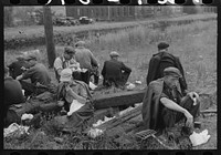 Railroad workers eating lunch along the railroad tracks, Windsor Locks, Connecticut by Russell Lee
