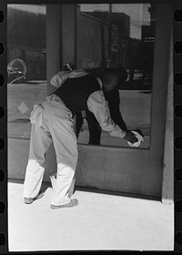 [Untitled photo, possibly related to:  washing store window, Taylor, Texas] by Russell Lee